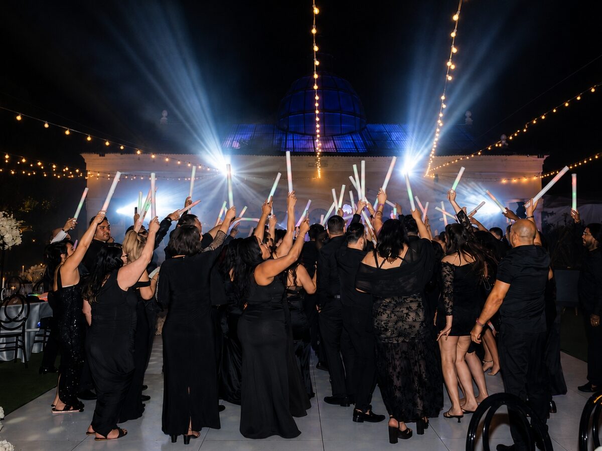 Pista de baile llena de energía bajo un show de luces estilo club en una boda