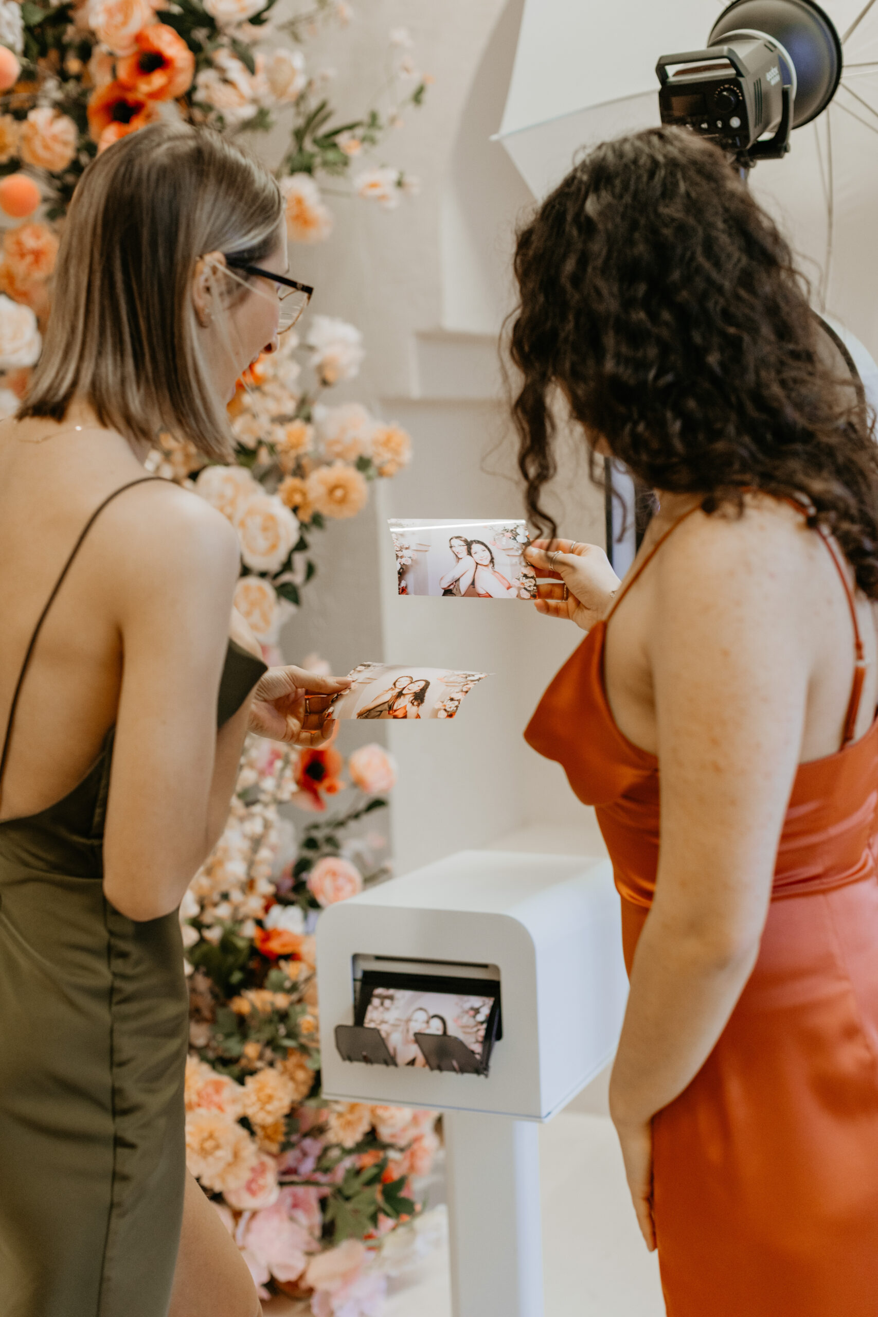 Photo booth set up against a soft floral backdrop