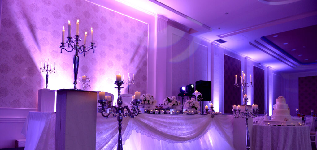 purple uplights for wedding reception