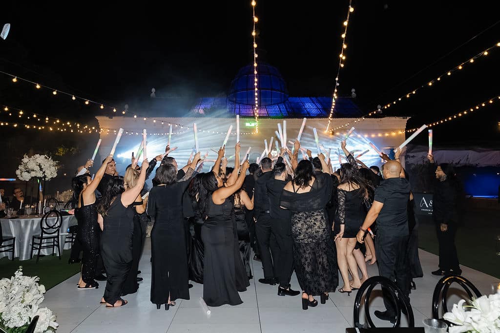 Guests dancing together during Michael & Andrew’s outdoor wedding reception at Villa Toscana Miami.