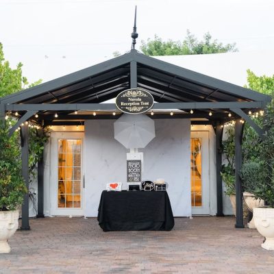 Outdoor wedding photo booth experience setup at Villa Toscana Miami reception tent in Homestead, FL.