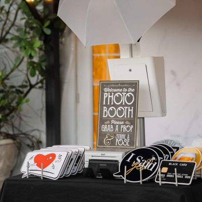 Customized wedding photo booth setup with props and instant prints by Xpress Entertainment at Villa Toscana Miami.