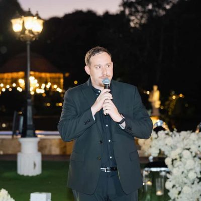 DJ Drew Segura speaking on the microphone during Michael & Andrew’s wedding reception at Villa Toscana Miami.