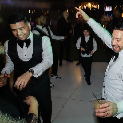 Michael & Andrew dancing with friends and family during their Villa Toscana Miami wedding reception.