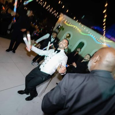 Andrew dancing with LED foam sticks during the high energy wedding reception at Villa Toscana Miami.