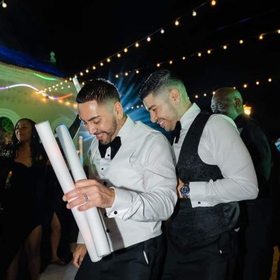 Michael & Andrew dancing with LED foam sticks during their wedding reception at Villa Toscana Miami.