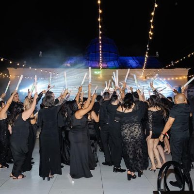 Guests dancing together during Michael & Andrew’s outdoor wedding reception at Villa Toscana Miami.