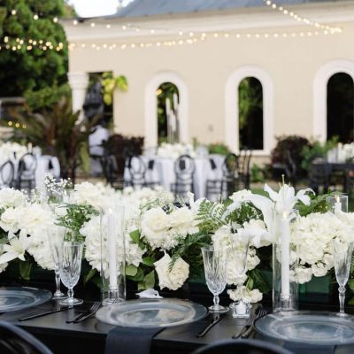 Luxury wedding tablescape with white florals and candle décor at Villa Toscana Miami wedding reception.
