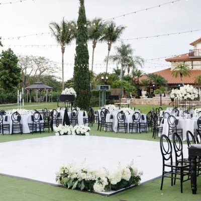 Elegant outdoor wedding reception setup with white dance floor and string lights at Villa Toscana Miami.